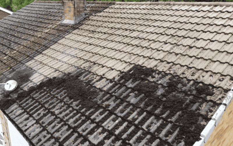 HLM Roofing Company cleaning a roof in Huntingdon